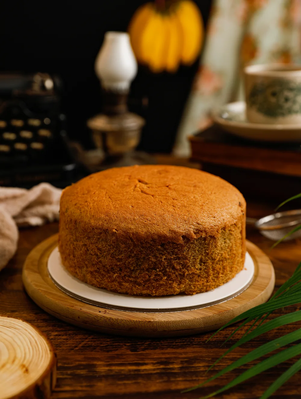 A golden Uncle Lee Confectionery cake on a wooden stand